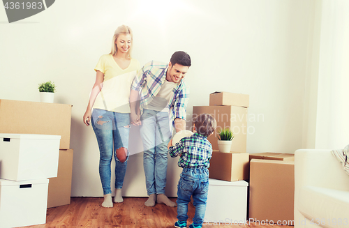 Image of happy family moving to new home and playing ball