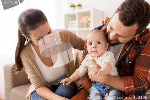 Image of happy family with baby at home