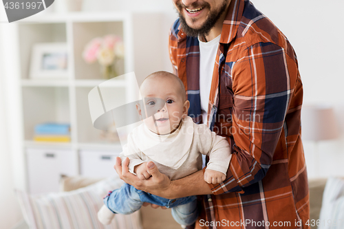 Image of happy father with little baby boy at home