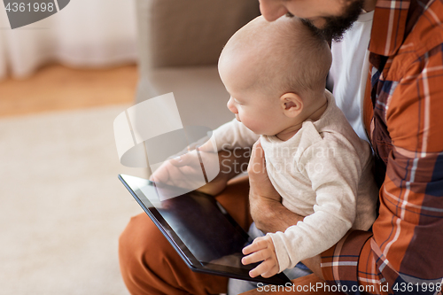 Image of happy father and baby boy with tablet pc at home