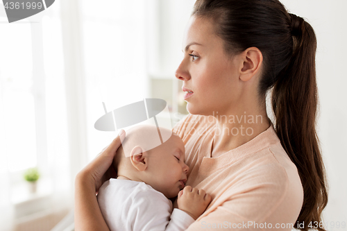 Image of close up of mother holding sleeping baby