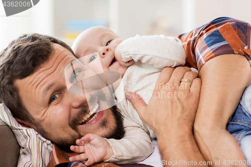 Image of close up of happy father with little baby at home