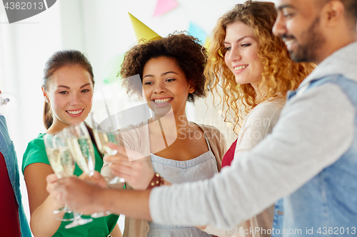 Image of friends clinking glasses of champagne at party