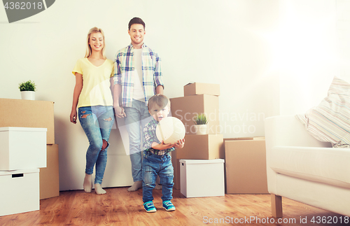 Image of happy family moving to new home and playing ball