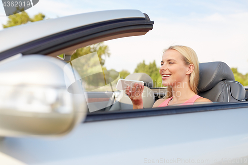 Image of woman recording voice on smartphone at car