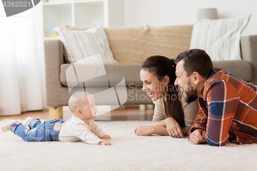 Image of happy family playing with baby at home