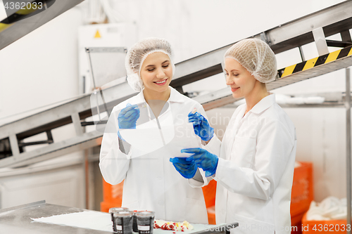 Image of women technologists tasting ice cream at factory