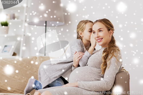 Image of happy pregnant woman and girl gossiping at home