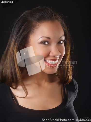 Image of Young black woman with big smile and braces