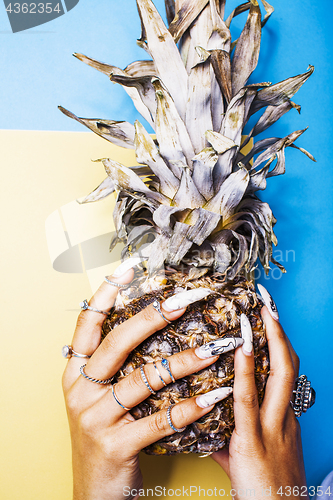 Image of lifestyle people concept. young pretty smiling indian girl with pineapple, asian summer fruits 