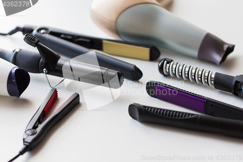 Image of hot styling and curling irons with hairdryers