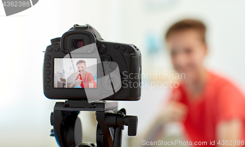 Image of camera recording video of blogger boy at home