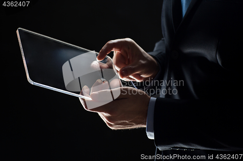 Image of close up of businessman with transparent tablet pc