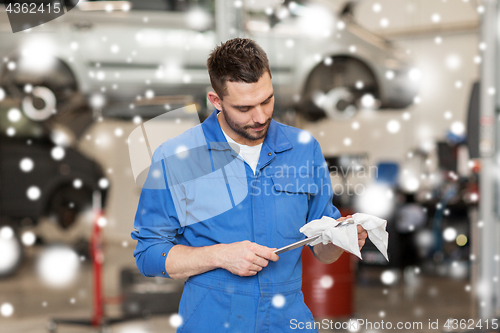 Image of auto mechanic or smith with wrench at car workshop