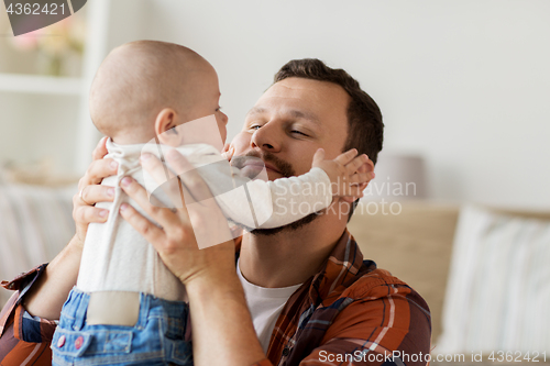 Image of close up of father with little baby boy at home