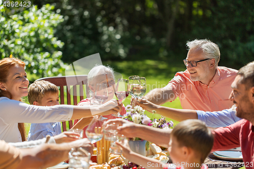 Image of happy family having dinner or summer garden party