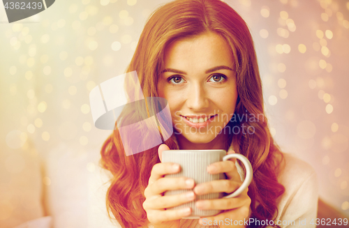 Image of close up of happy woman with coffee cup at home