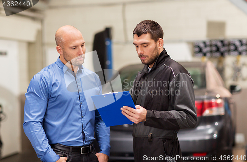 Image of auto mechanic and customer at car shop