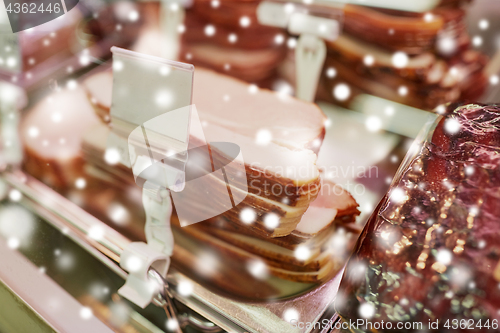 Image of ham at grocery store stall