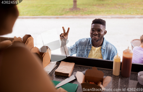 Image of african american man ordering wok at food truck