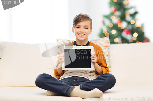 Image of smiling boy with tablet pc at home at christmas