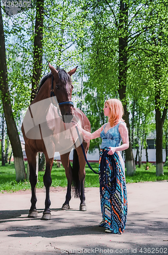 Image of Young Woman With A Horse