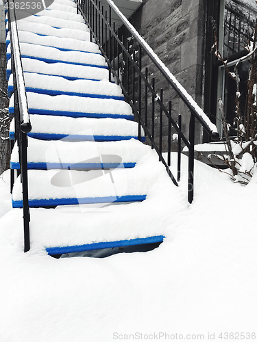 Image of Townhouse staircase covered in snow