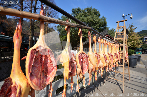 Image of Rows of cured meat hanging to dry