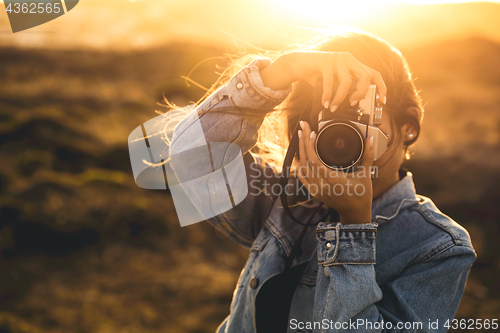 Image of Woman Taking Picture Outdoors