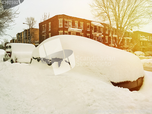 Image of Cars entirely covered by snow