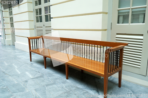 Image of Wooden bench in front of a wall