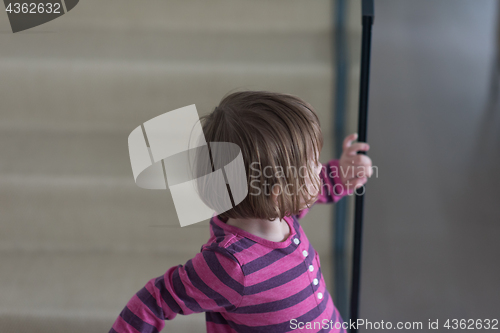 Image of little cute girl enjoying on the stairs