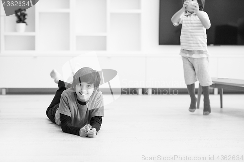 Image of boys having fun with an apple on the floor