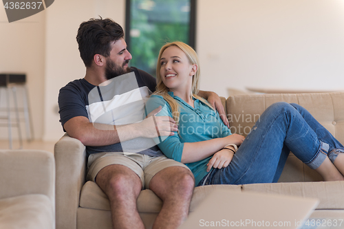 Image of young happy couple relaxes in the living room