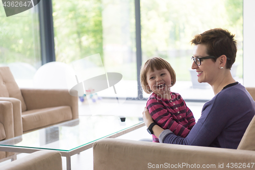 Image of mother and cute little girl enjoying their free time