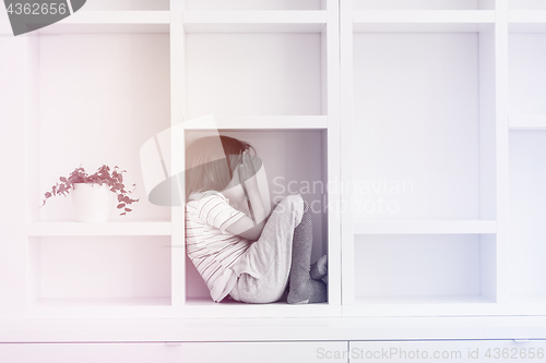 Image of young boy posing on a shelf