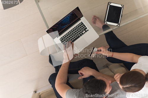 Image of happy young couple buying online