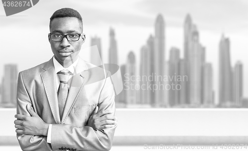 Image of Young black businessman in front of the big city