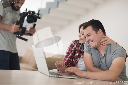 Image of happy young couple buying online