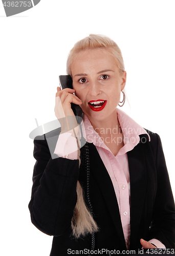 Image of Business woman talking on an old phone