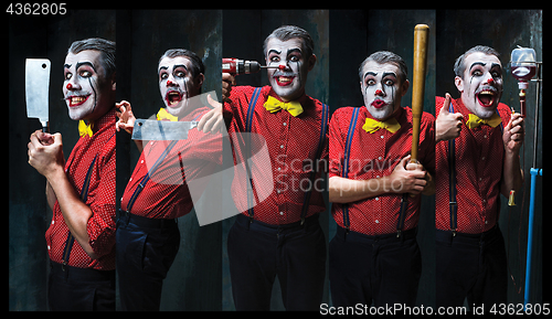 Image of The scary clown holding a knife on dack. Halloween concept