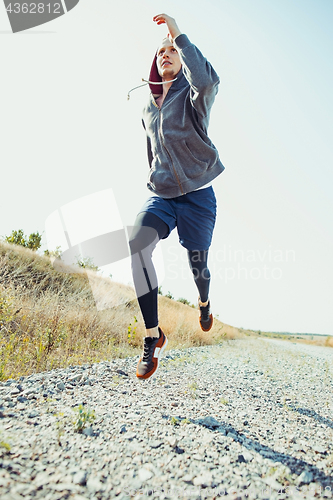 Image of Running sport. Man runner sprinting outdoor in scenic nature. Fit muscular male athlete training trail running for marathon run.