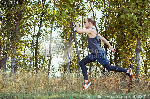 Image of Running sport. Man runner sprinting outdoor in scenic nature. Fit muscular male athlete training trail running for marathon run.