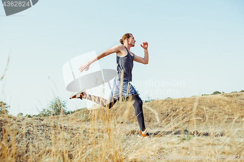 Image of Running sport. Man runner sprinting outdoor in scenic nature. Fit muscular male athlete training trail running for marathon run.