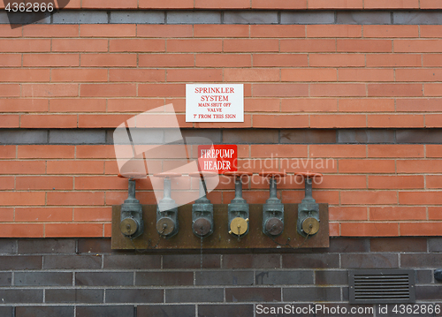 Image of Firepump test headers on red brick wall