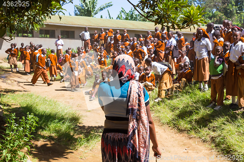 Image of Children in uniforms playing in the cortyard of primary school in rural area near Arusha, Tanzania, Africa.