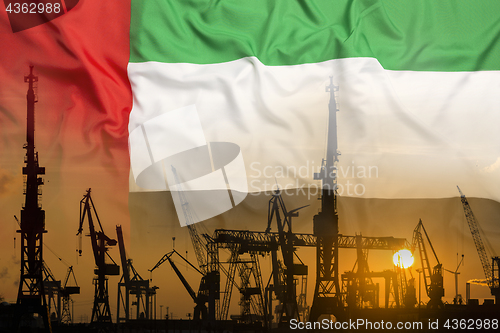 Image of Industrial concept with United Arab Emirates flag at sunset