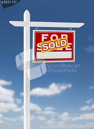 Image of Right Facing Sold For Sale Real Estate Sign on a Blue Sky with C