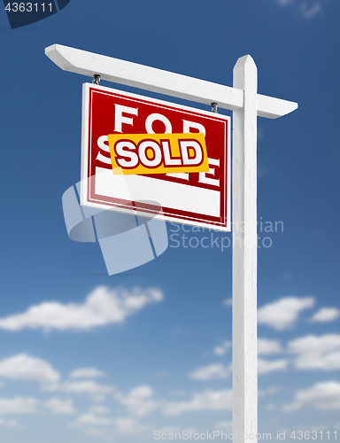 Image of Left Facing Sold For Sale Real Estate Sign on a Blue Sky with Cl