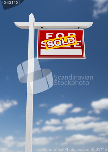 Image of Right Facing Sold For Sale Real Estate Sign on a Blue Sky with C